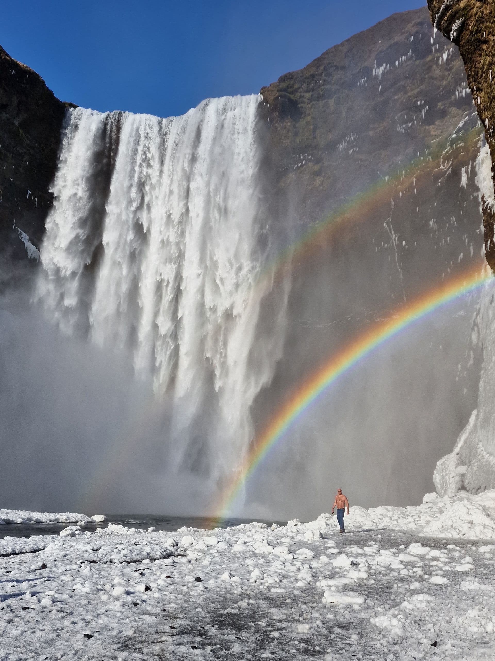 Roy Castleman standing at the base of a waterfall in Iceland